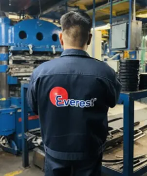 Everest Group employees collaborating in industrial rubber production plant