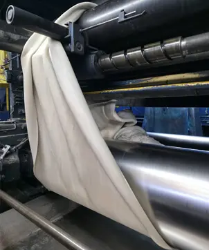 Technical personnel operating mill for raw rubber contract manufacturing at Everest